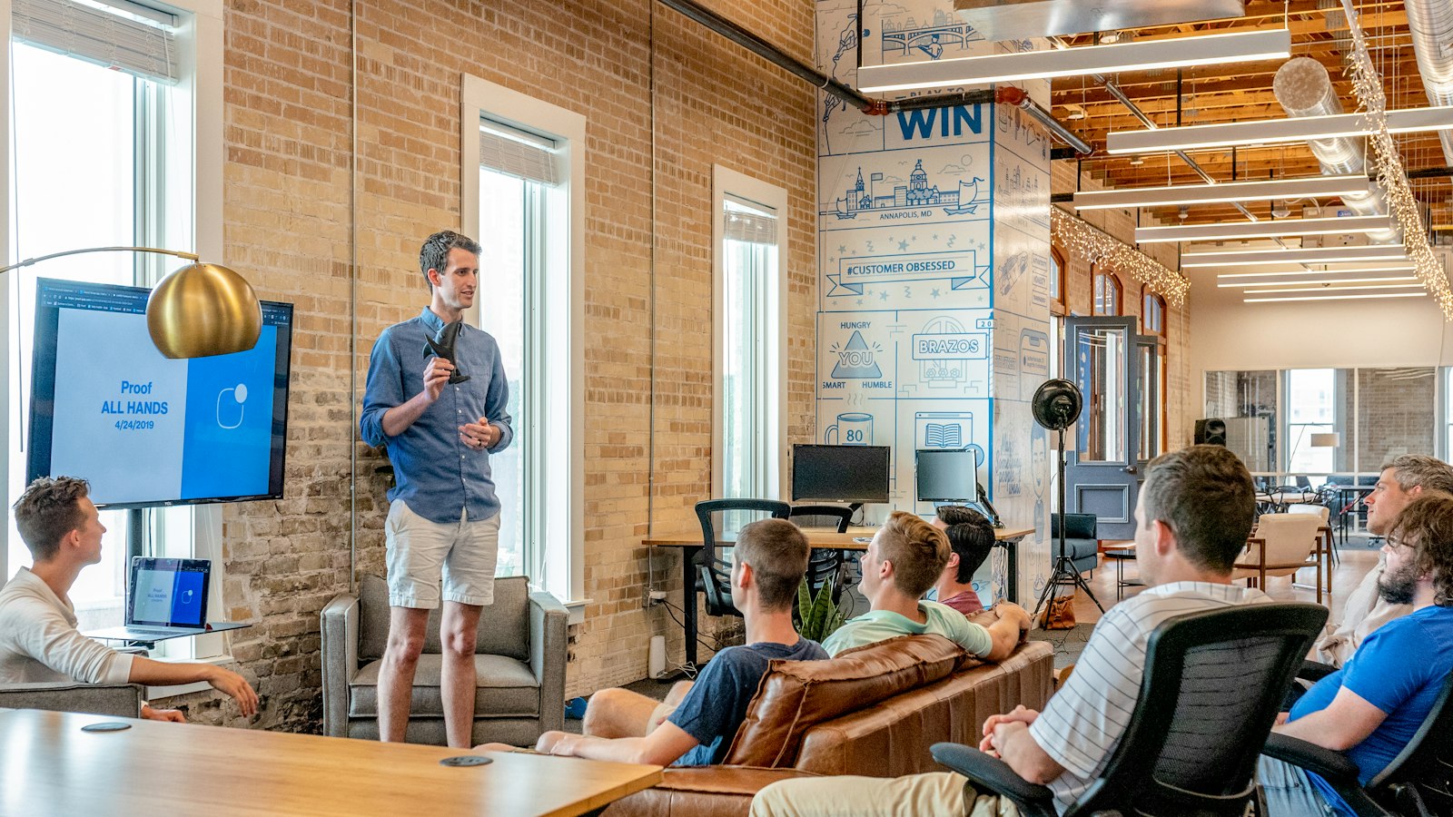 Founder pitching to a VC partner over espresso and a laptop.