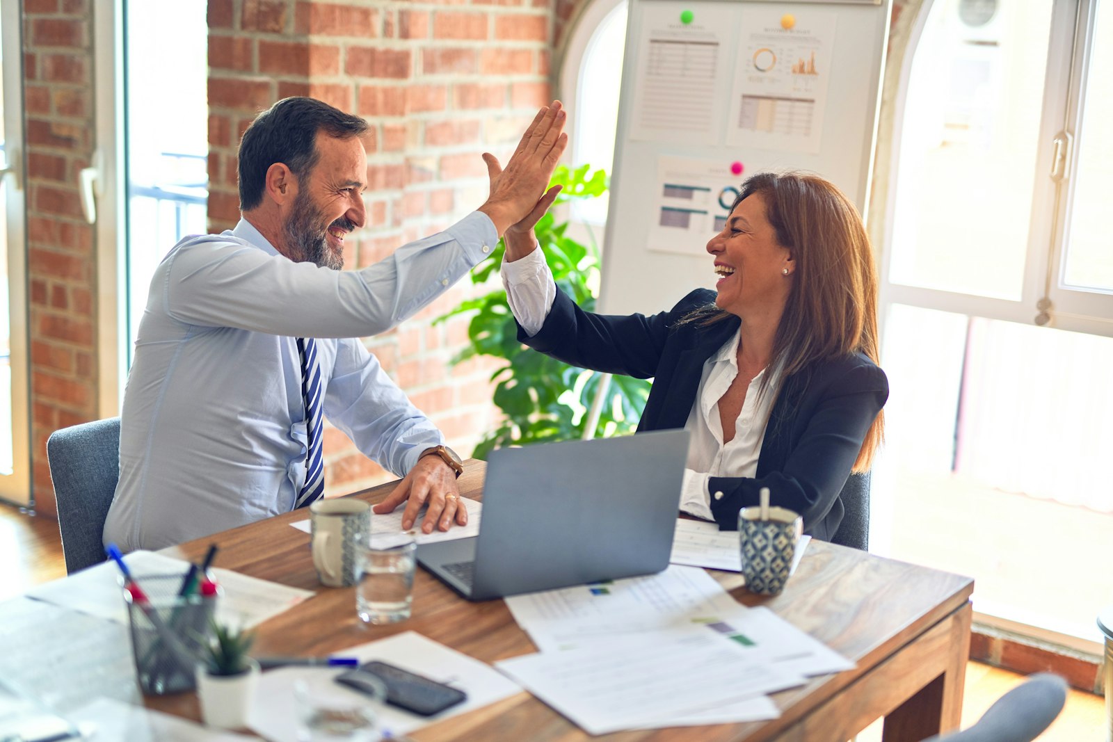 Recruiter interviewing a candidate in a warm meeting room.