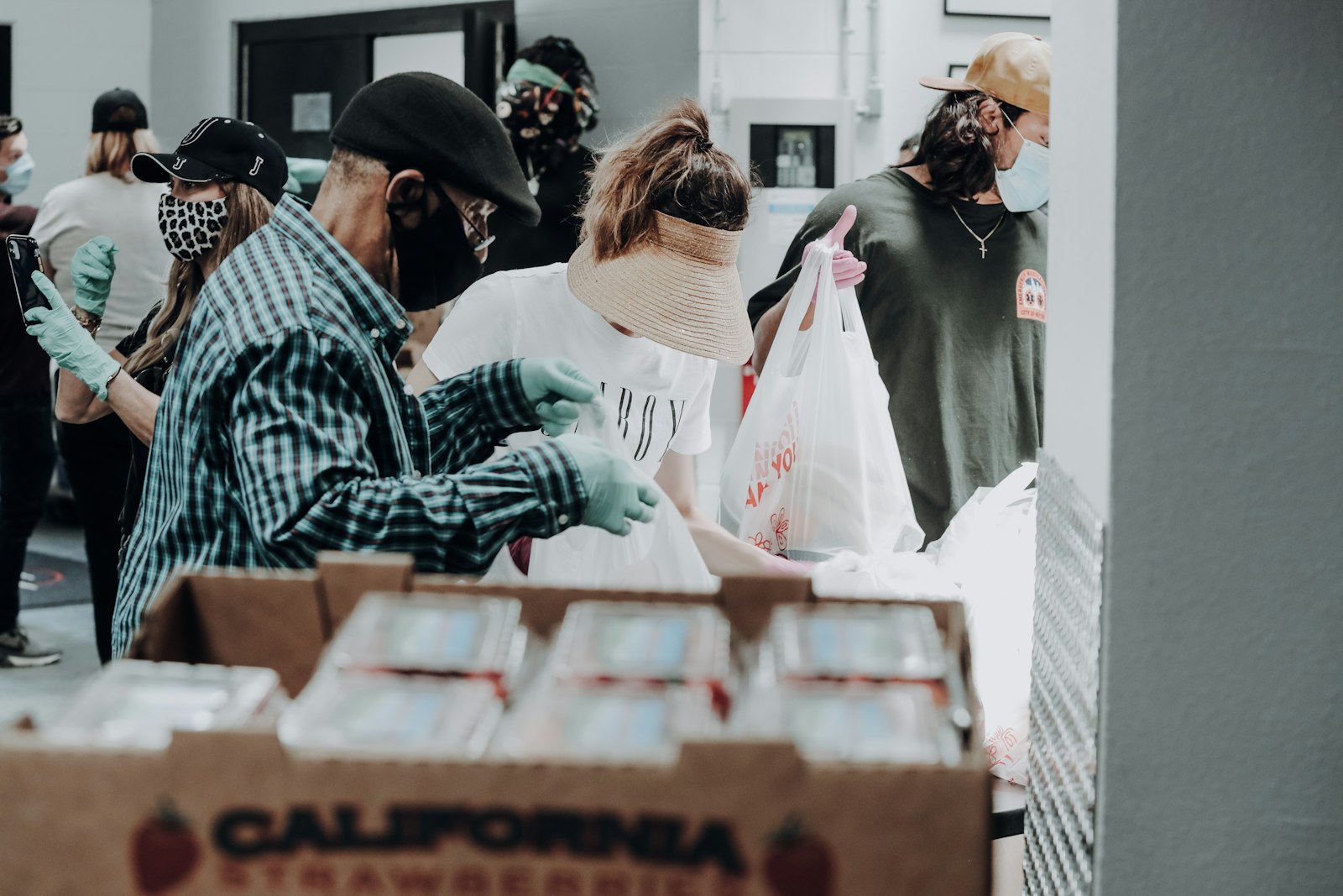 Community volunteers packing supplies at a warm-lit distribution hub.