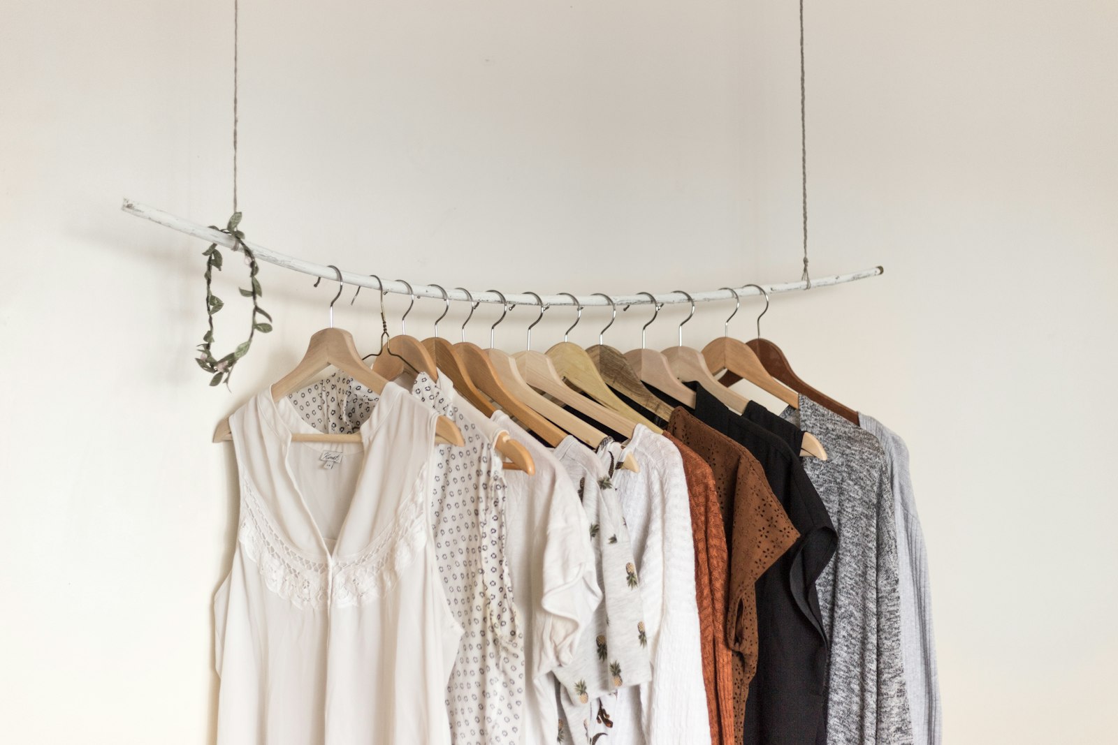 Atelier rack of curated garments in soft daylight.
